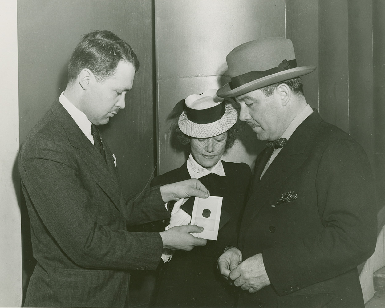 Ann Hind shows the One-Cent Magenta to stamp collector Ernest Kehr and Grover Whalen, president of the New York World’s Fair.
