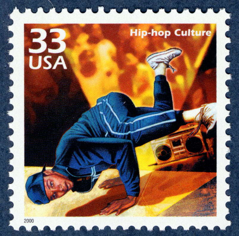 Postage stamp depicting breakdancing man standing on his hands with feet kicked in the air; boom box in background.