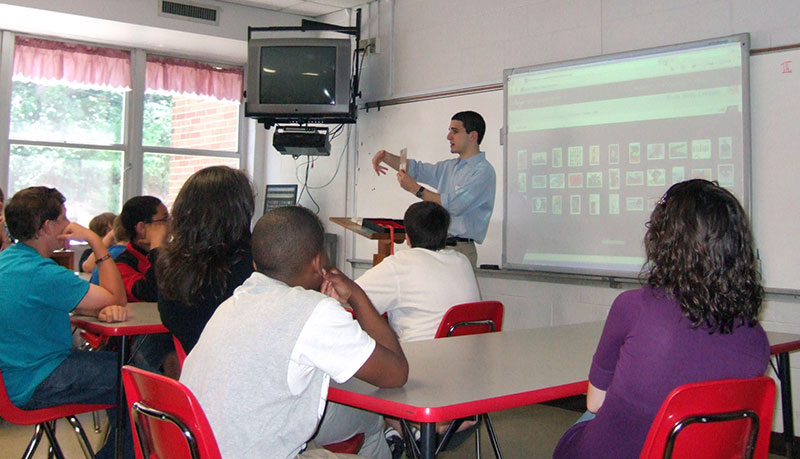 Alex Haimann presenting to a classroom of students