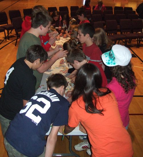 A group of students sorting through stamps