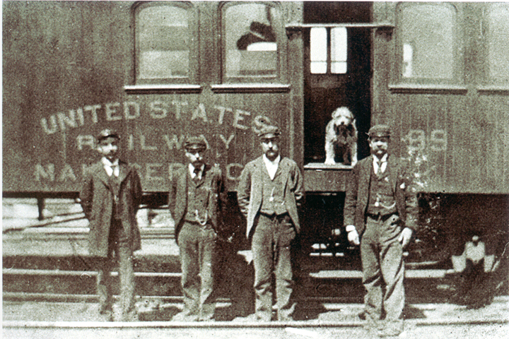 Owney posing with Railway Mail clerks
