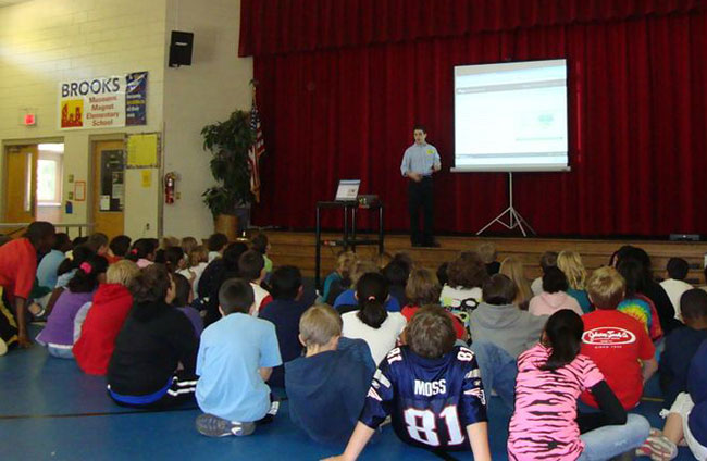 A presentation in a auditorium at Brooks Museums Magnet Elementary School