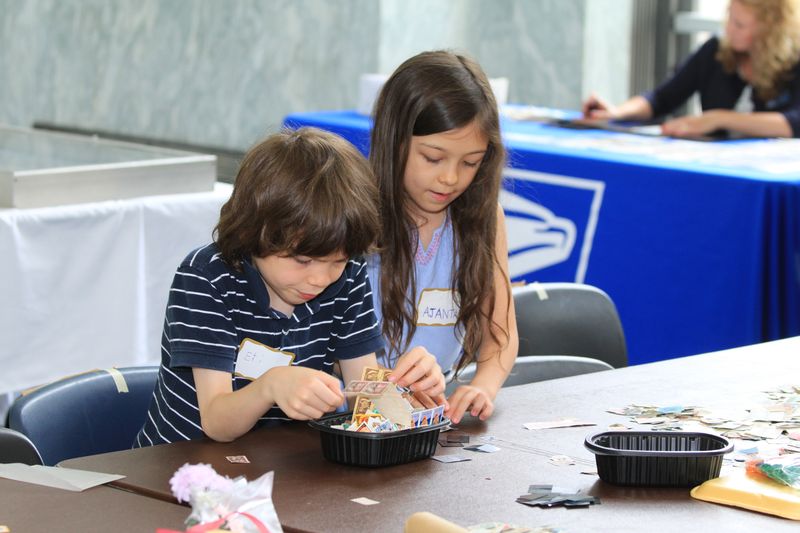 Two visitors involved in a stamp activity