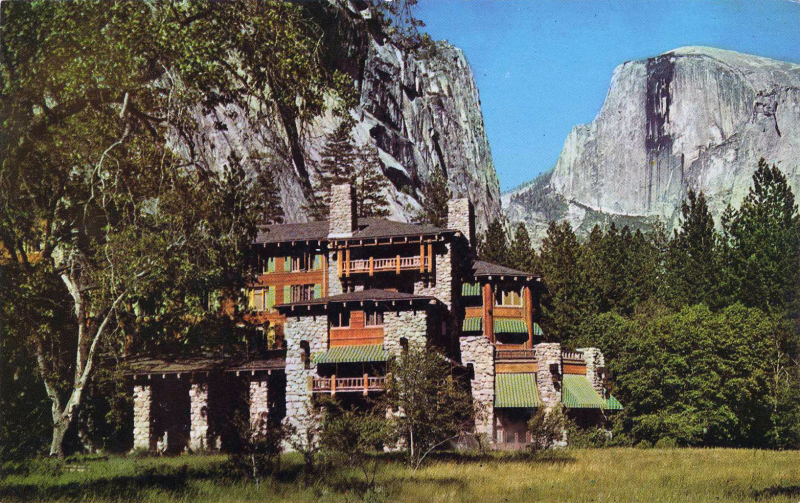 The Majestic Yosemite Hotel and Half Dome rock formation in the background