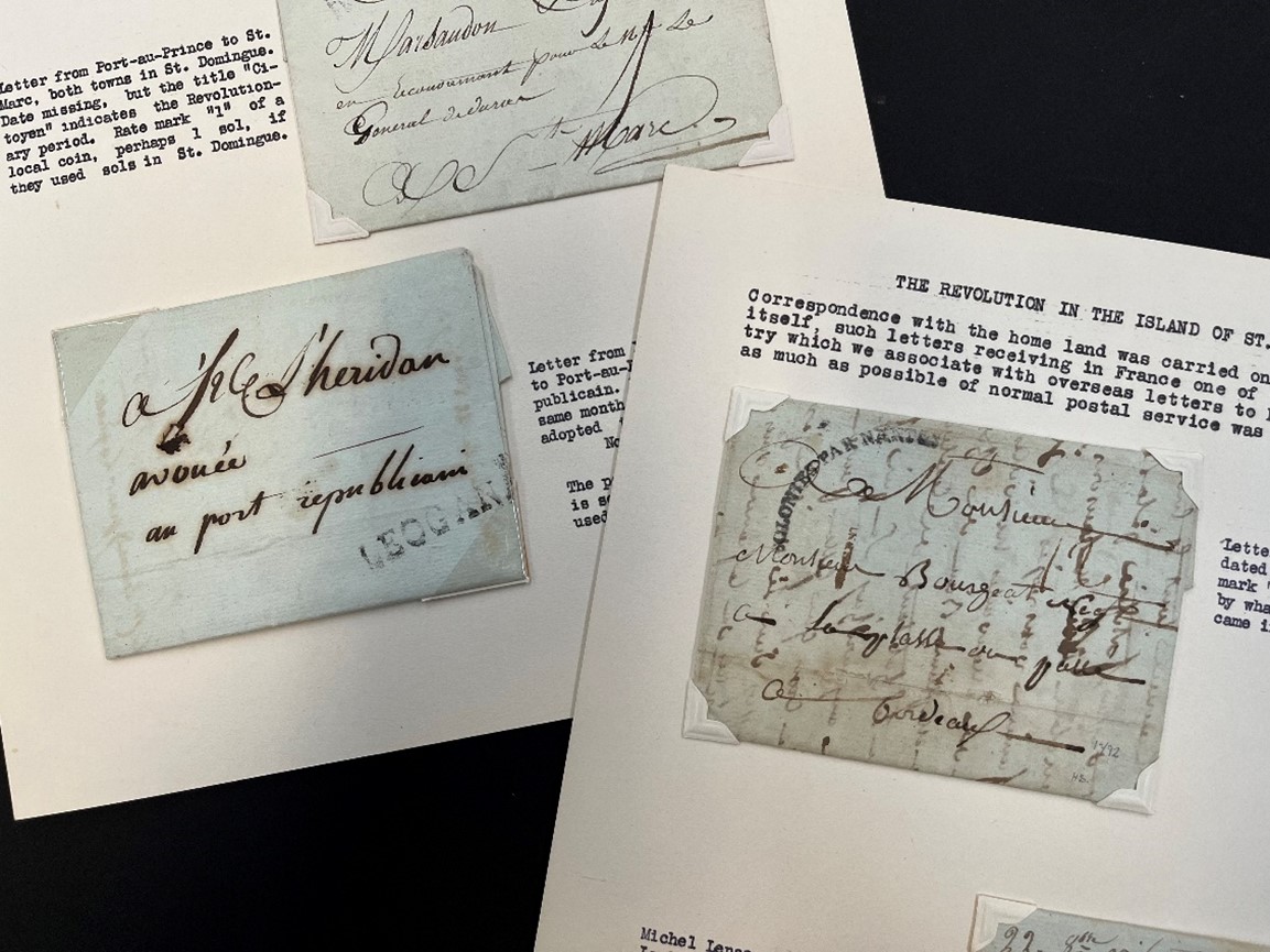 Photograph of 2 pages of collectors album with close up images of folded up letters adorned with elaborate, handwritten cursive