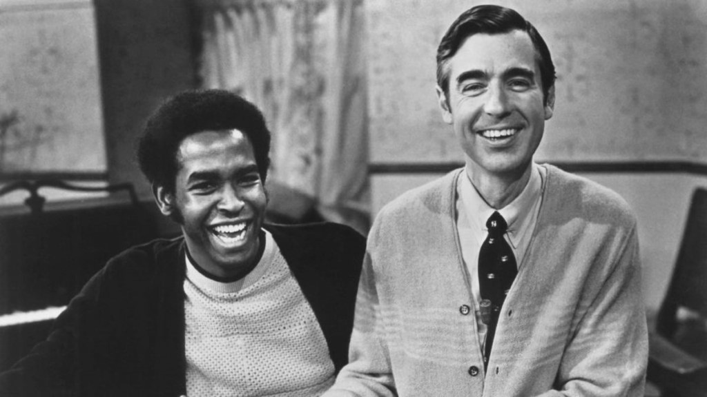 Black and white photograph of two seated, smiling men. On the left, François Clemons and on the right, Fred Rogers.