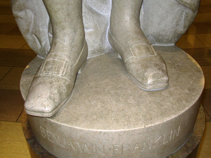 Worn shoes of the statue