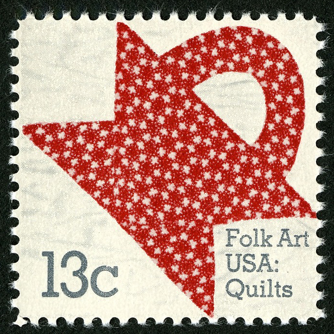 13 cent postage stamp featuring a basket design on a quilt