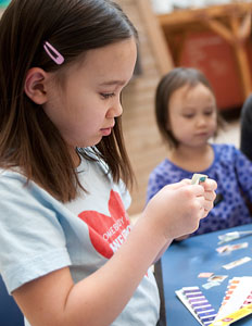 Two little girls looking at stamps