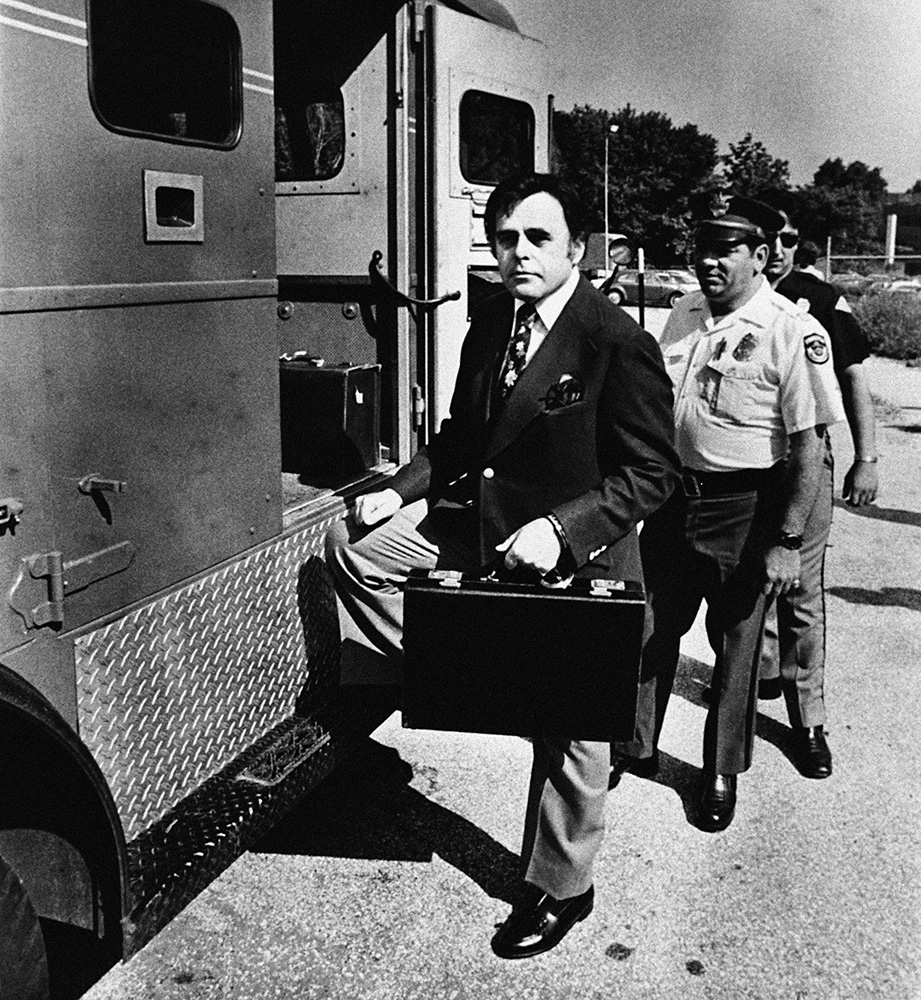 Irwin Weinberg steps into an armored car with a briefcase containing the One-Cent Magenta handcuffed to his wrist, Philadelphia, 1976.