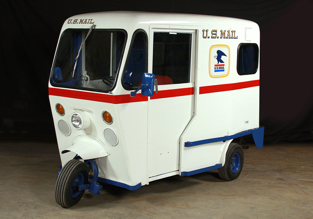 A three-wheeled Mailster mail delivery truck