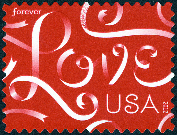 Forever stamp showing Love written with ribbons