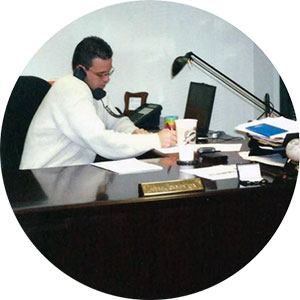 Adam at office desk on phone