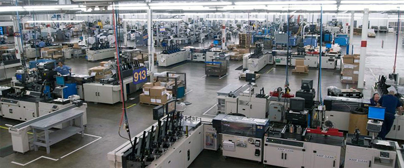 Large Mailing Department room with workers among mailing machines.