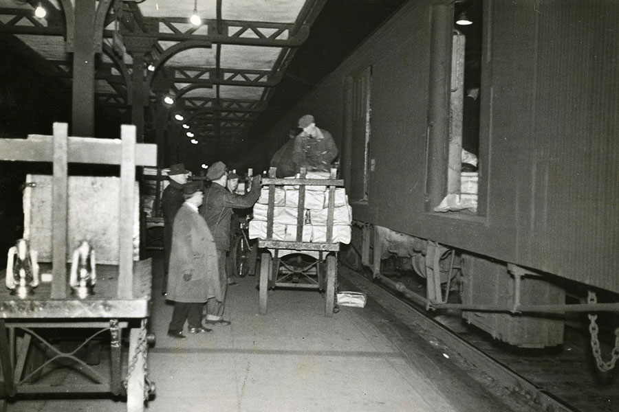 Unloading LIFE shipment from American Express car, Boston and Albany R.R. at Worcester, Man.