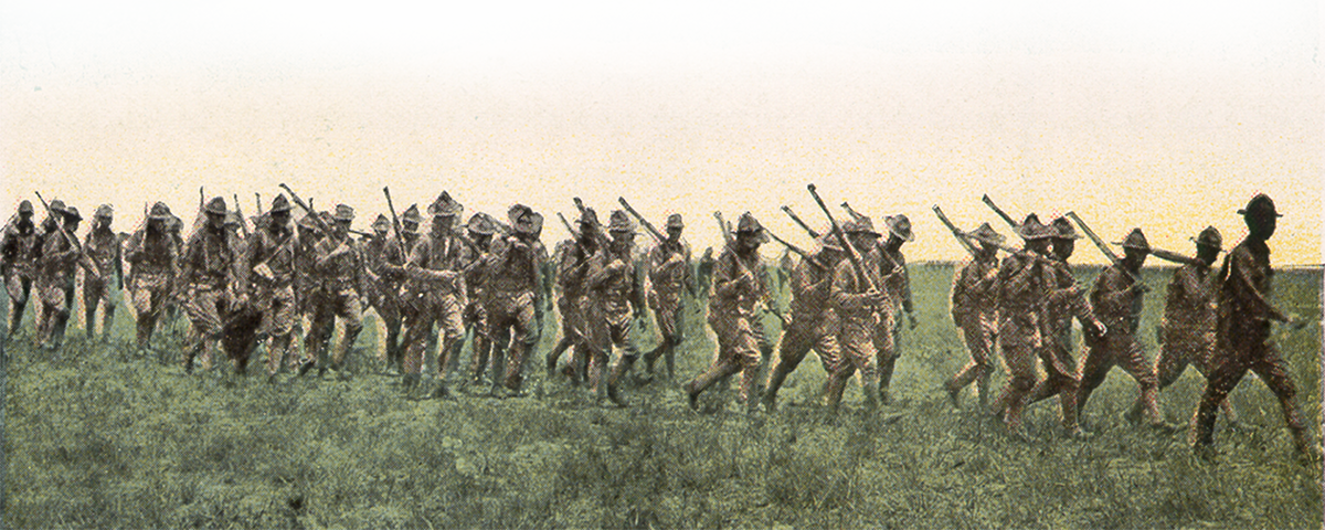 soldiers carrying guns in a field