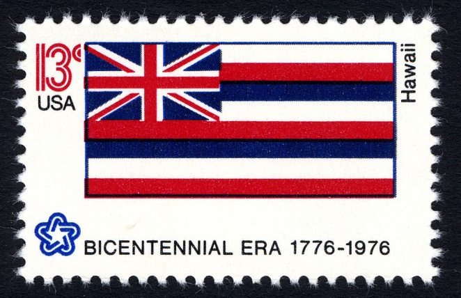 Hawaii flag stamp with the British Union Jack flag shown in the left corner in recognition of Great Britain’s early friendship and goodwill with Hawaii in the mid-19th century.