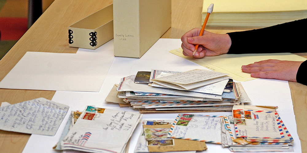 A preservation worker labeling folders