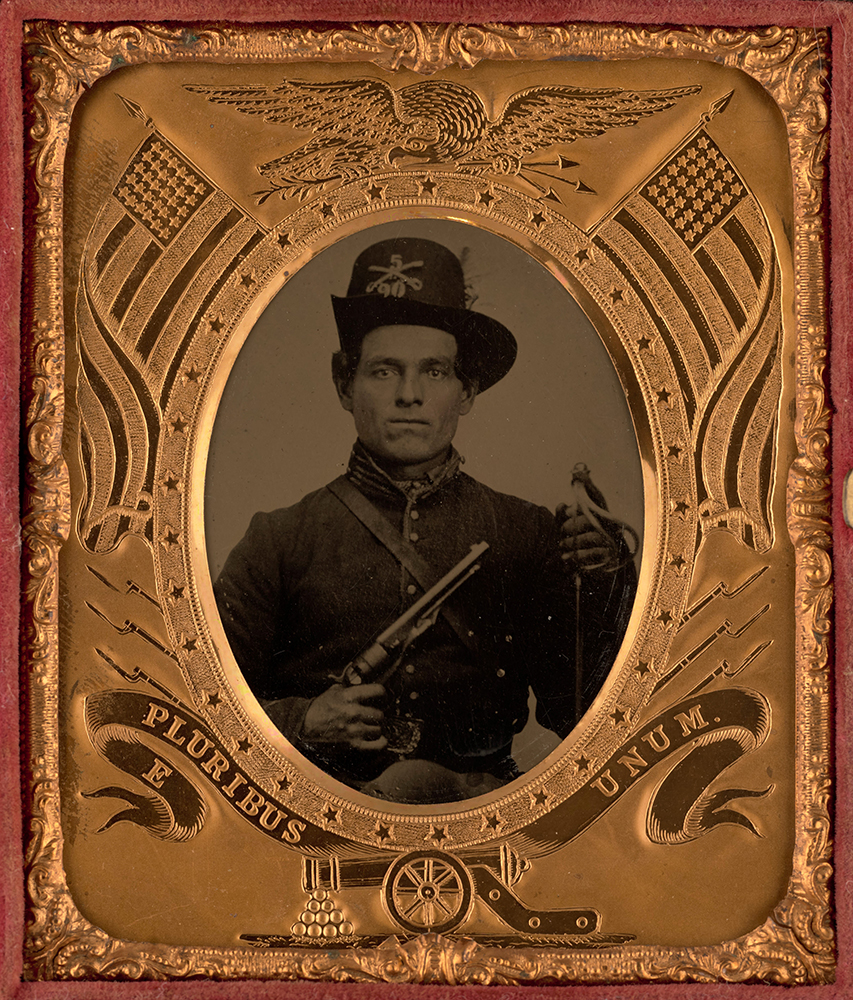 Framed tintype of unidentified male soldier of the 5th Indiana Cavalry Regiment in uniform with Colt Army Model 1860 revolver and sword