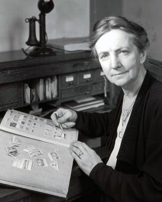 Catherine L. Manning with a stamp collecting book