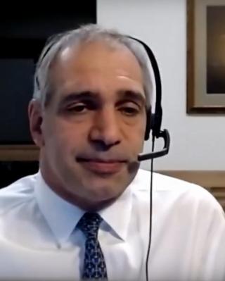 Yamil Kouri wearing a headset presenting an online lecture